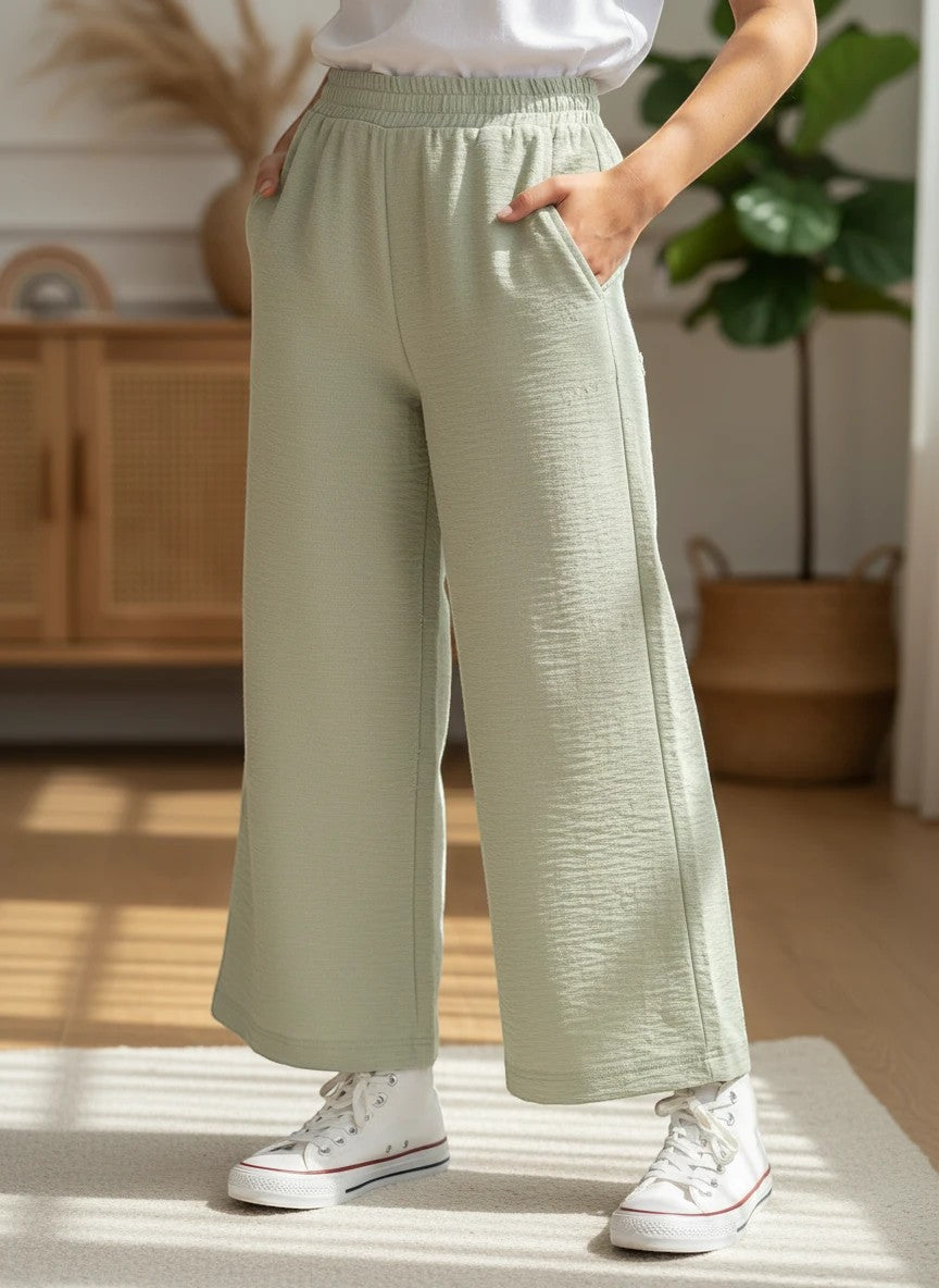The Nile Luxuries girls' outfit set with a white t-shirt and sage green textured wide-leg pants with side pockets.