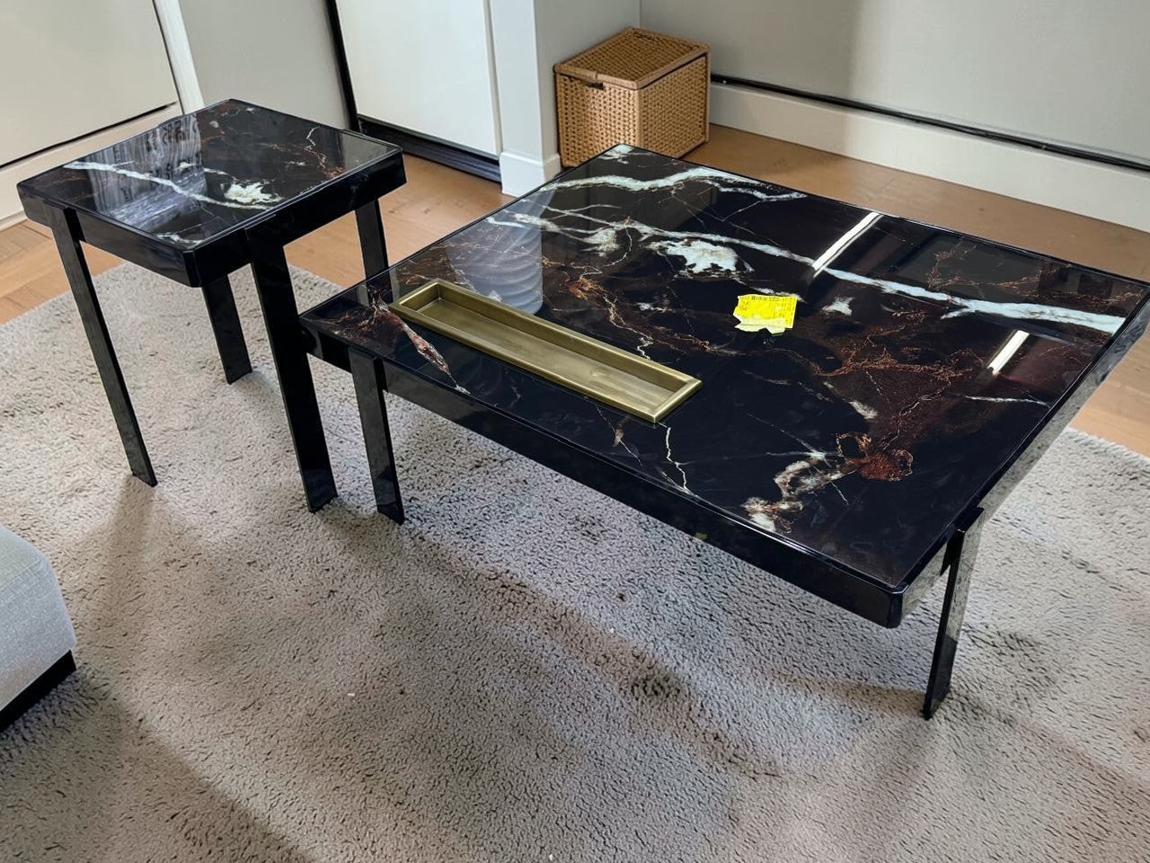 The Nile Luxuries nesting accent tables with black marble-effect tops and black metal legs. Features white and copper veining.