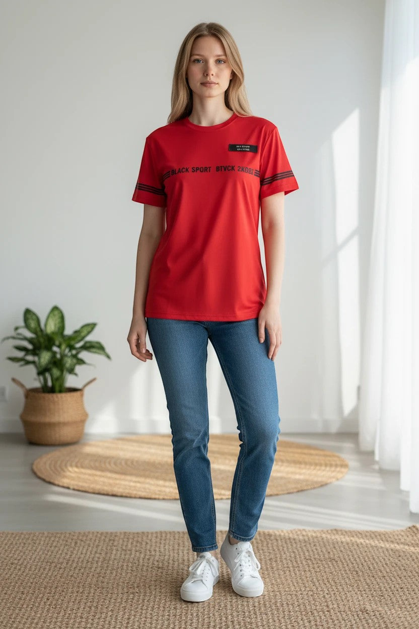 The Nile Luxuries red performance t-shirt with black graphic print and sleeve stripes worn by a woman with blue jeans.