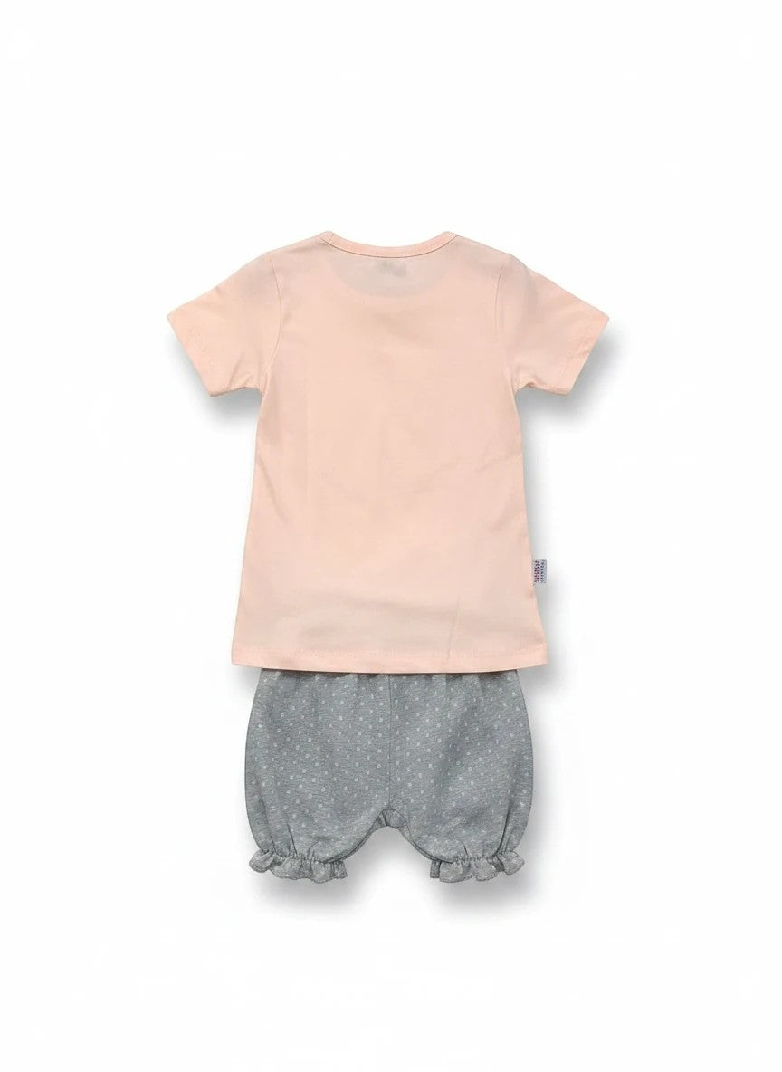 The Nile Luxuries toddler set with a plain peach t-shirt and grey polka-dot ruffled bloomers, back view.