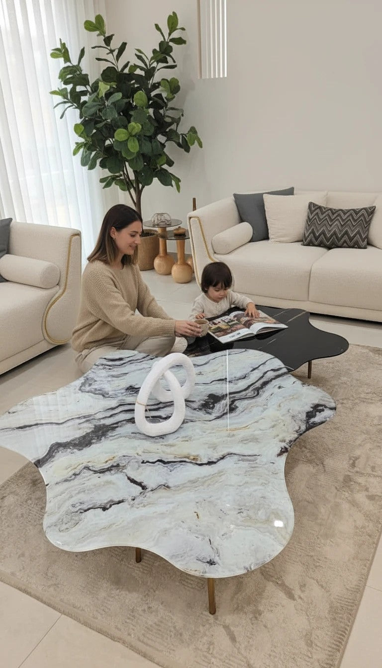 The Nile Luxuries modern coffee table set with organic marble-effect tops and black metal legs.