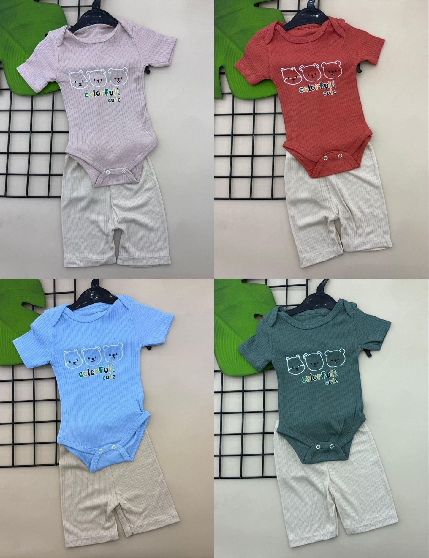 The Nile Luxuries baby bear print ribbed bodysuit and shorts set in pink, coral, blue, and green. Soft knit fabric with snap closures.