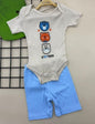 The Nile Luxuries baby bodysuit and shorts set in beige ribbed knit with three bear graphics and blue shorts. Short sleeves, snap closures.
