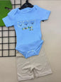 The Nile Luxuries baby blue ribbed bodysuit with three bear graphic and beige ribbed shorts. Short-sleeved.