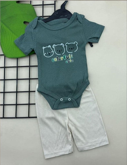 The Nile Luxuries green ribbed knit baby bodysuit with bear print and white shorts. Short sleeves, snap closure.