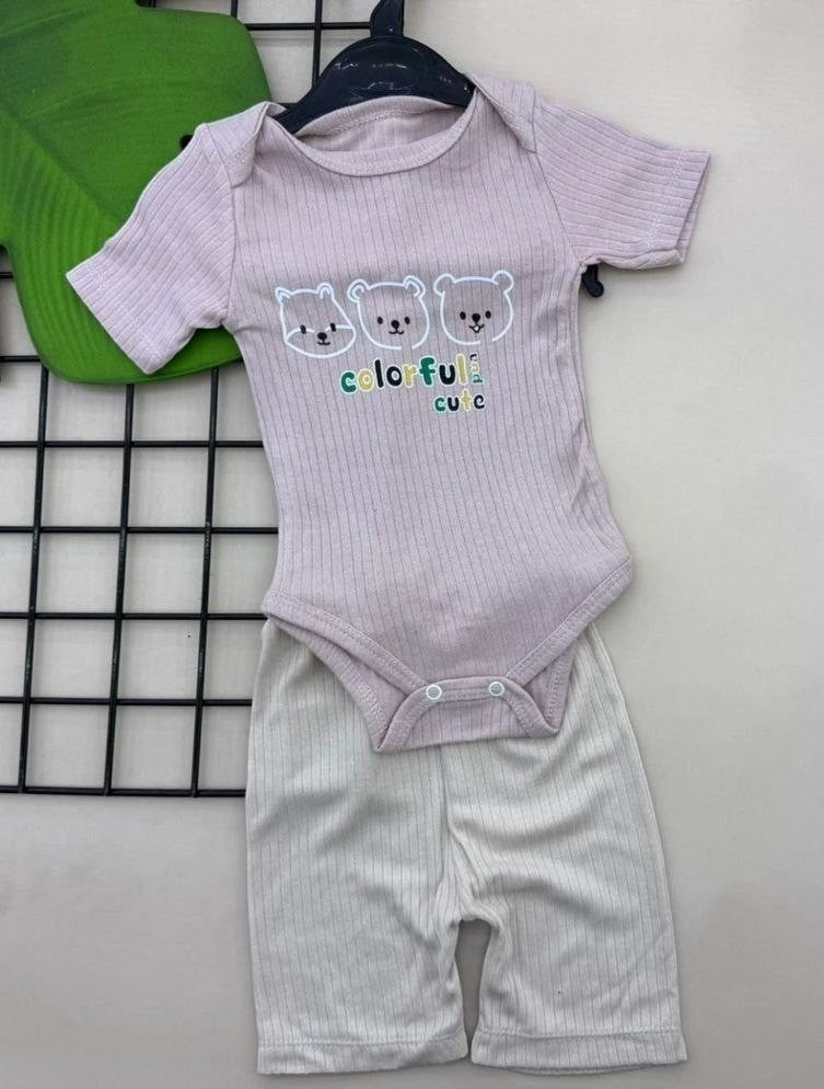The Nile Luxuries baby pink ribbed bodysuit with three bear print and beige ribbed shorts. Short-sleeved with snap closure.
