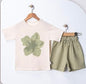 The Nile Luxuries baby girls' light cream t-shirt with green floral graphic and matching olive green shorts.