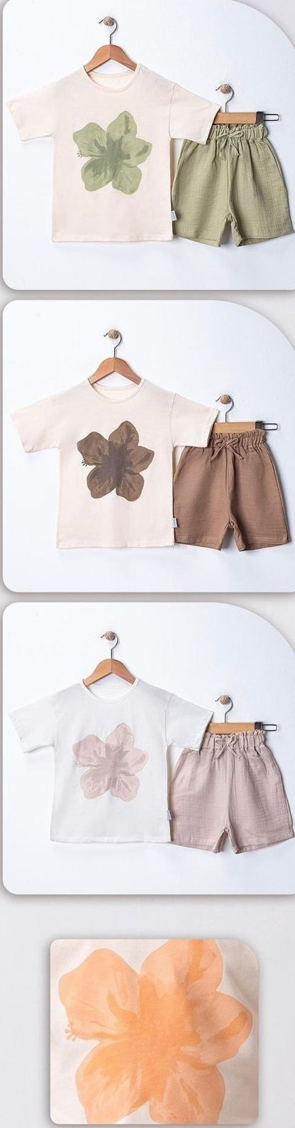 The Nile Luxuries baby boys' cotton blend graphic bodysuit and shorts set in cream with green flower graphic and olive green shorts.