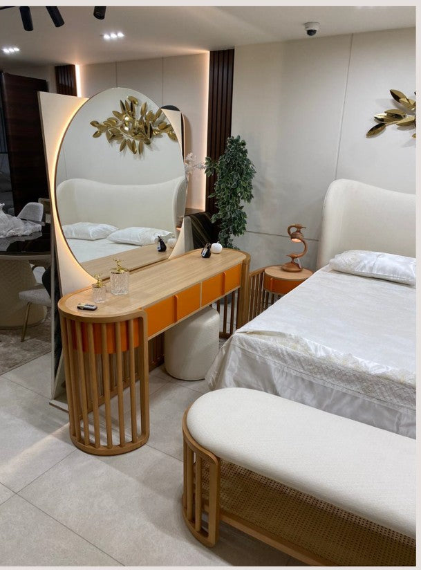 The Nile Luxuries modern bedroom set with upholstered bed, orange vanity, and rattan bench.