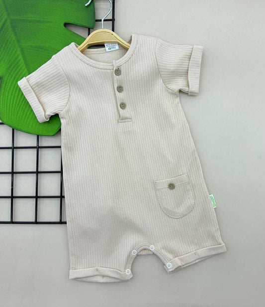 The Nile Luxuries beige ribbed cotton baby romper with short sleeves, front pocket, and three-button placket.