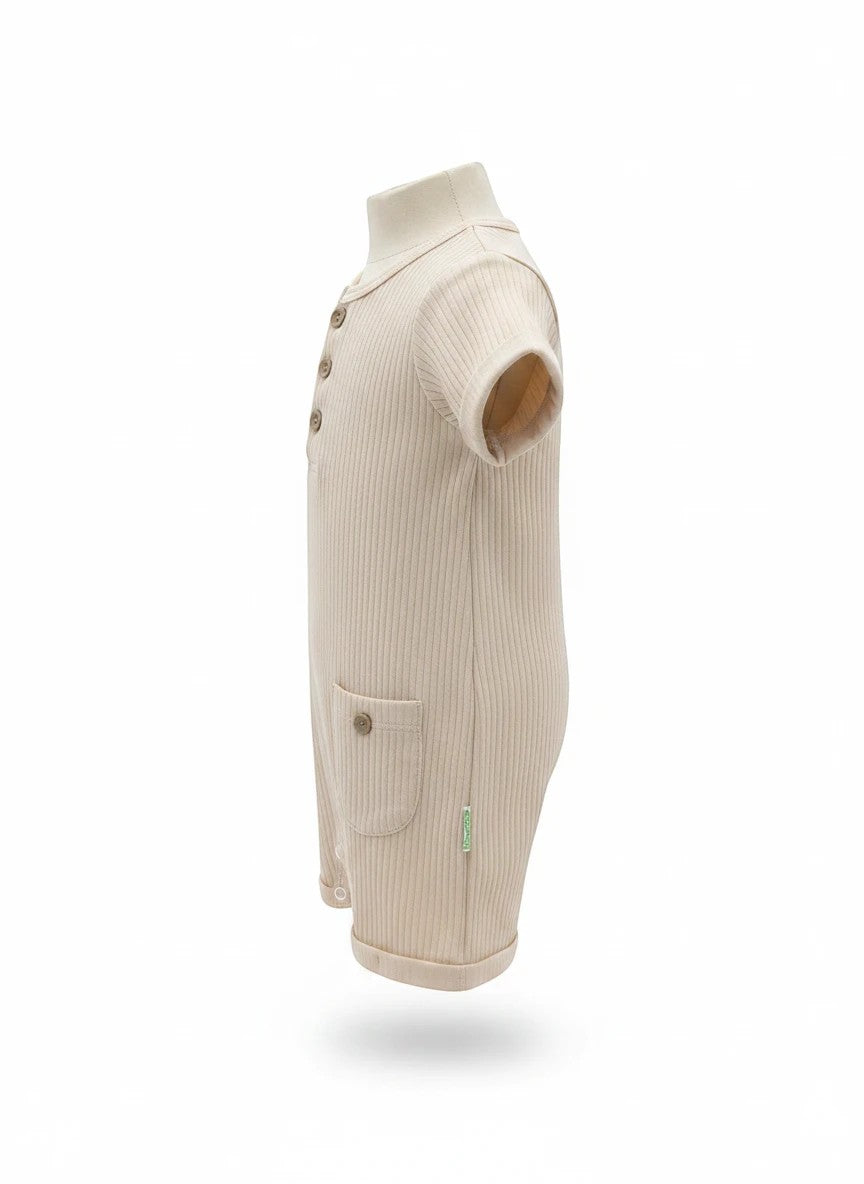 The Nile Luxuries beige ribbed cotton baby romper with a button placket, short sleeves, and a front pocket side view.