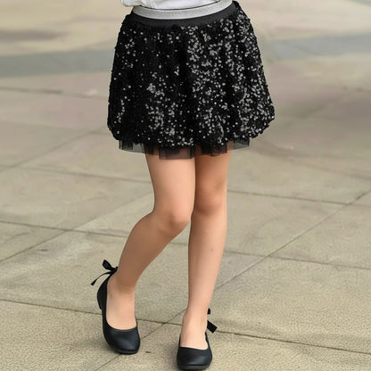 The Nile Luxuries girls black sequin tulle skirt with metallic elastic waistband worn with black ballet flats