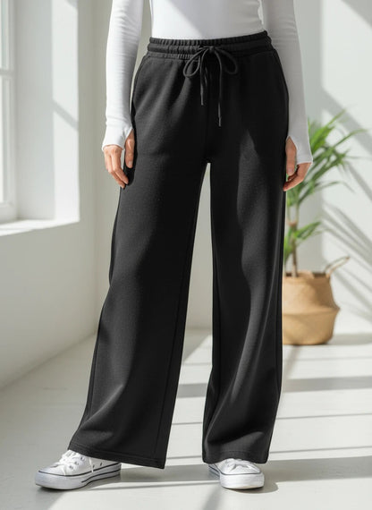 The Nile Luxuries black wide-leg lounge pants with an elastic drawstring waistband and side pockets.