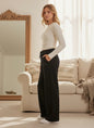 The Nile Luxuries NICKEL SPORTWEAR black wide-leg lounge pants with drawstring waist and pockets on a model.