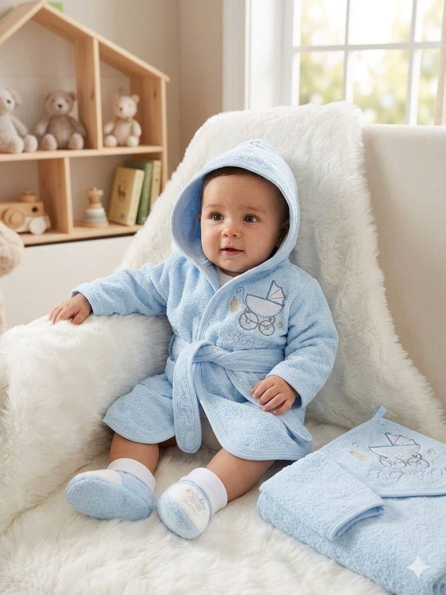 Baby wearing a light blue The Nile Luxuries plush hooded bathrobe and matching slippers with embroidered pram design