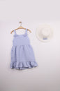 The Nile Luxuries blue gingham ruffle dress with bow straps and matching hat, perfect for summer.