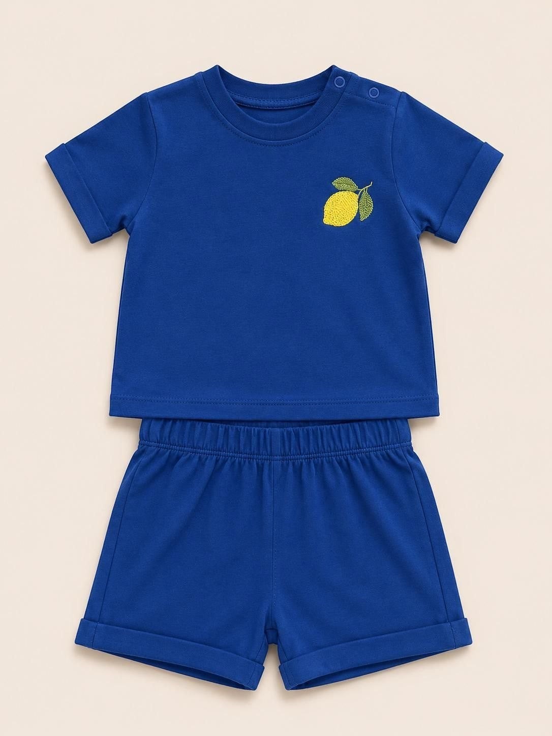 The Nile Luxuries toddler blue short sleeve shirt and shorts set with a yellow lemon embroidery on the chest.