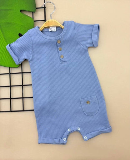 The Nile Luxuries blue ribbed cotton baby romper with short sleeves, button placket, and a front pocket.