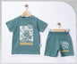 The Nile Luxuries Bobdog Baby T-shirt and shorts set in teal cotton with cartoon graphic and "Street Style" text.