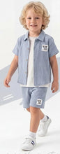 The Nile Luxuries boys' sky blue gauze shirt and shorts set with embroidered patch. Short-sleeved collared shirt and elastic-waist shorts.
