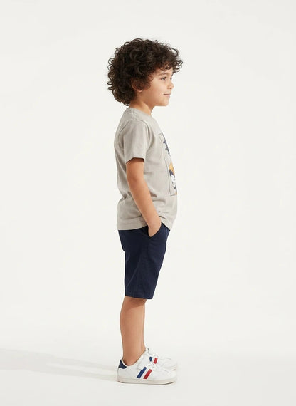 The Nile Luxuries boys grey Dragon Ball Z Goku graphic t-shirt worn by a young boy in profile view.