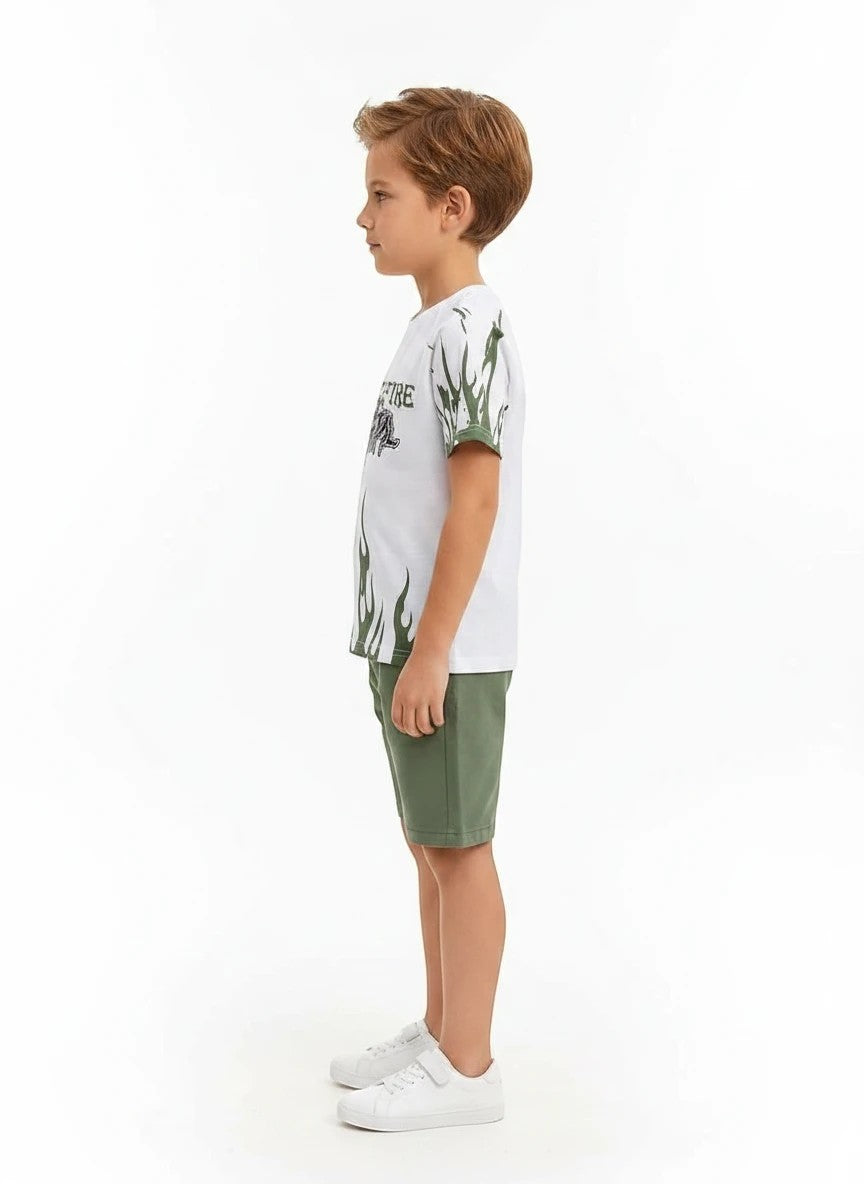 The Nile Luxuries boys white graphic t-shirt with green flame print and matching green shorts, side view.
