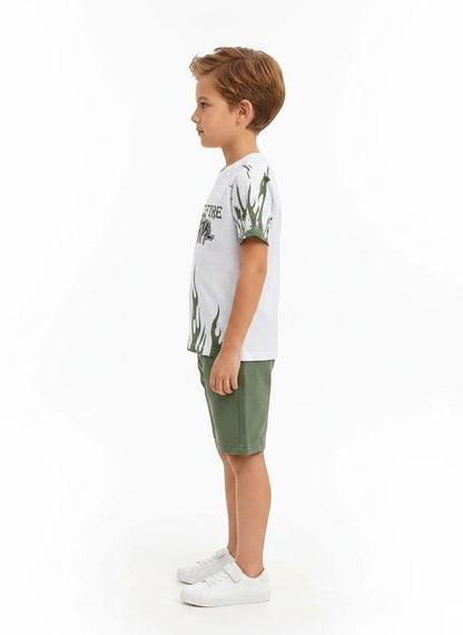 The Nile Luxuries boys white graphic t-shirt with green flame print and matching green shorts, side view.