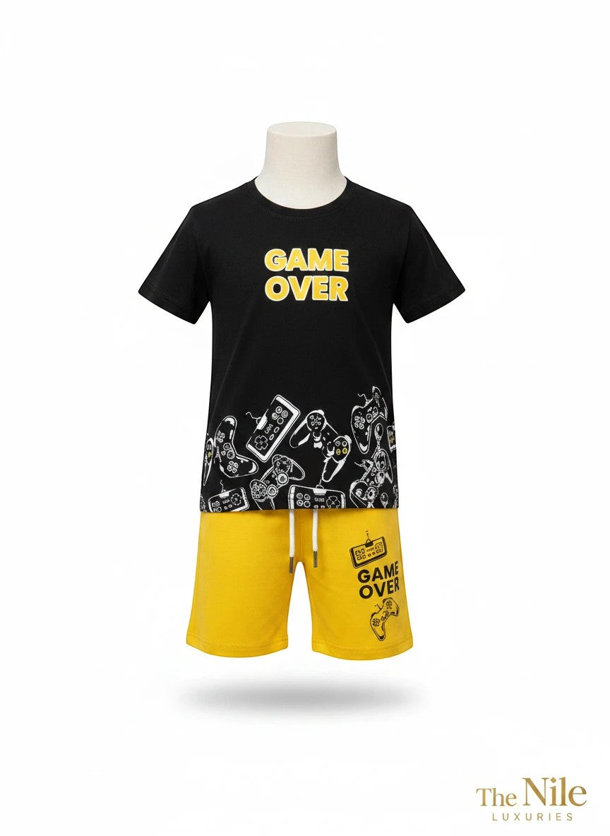 The Nile Luxuries boys black graphic t-shirt with Game Over print and yellow drawstring shorts with gaming motifs.