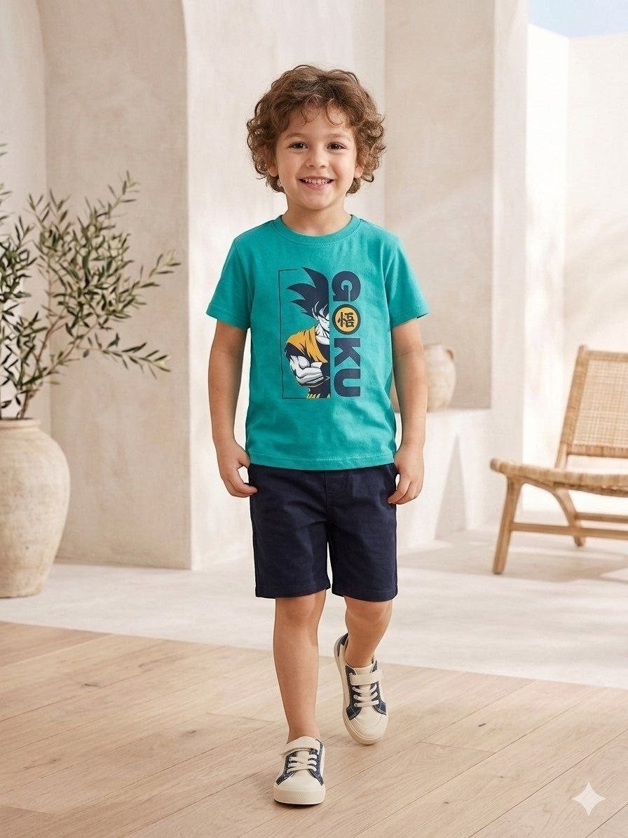 The Nile Luxuries boys teal Dragon Ball Z Goku graphic t-shirt paired with navy shorts on a smiling young boy.