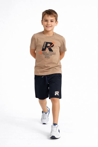The Nile Luxuries boys' tan graphic t-shirt and navy blue athletic shorts set with drawstring waist and sneakers.