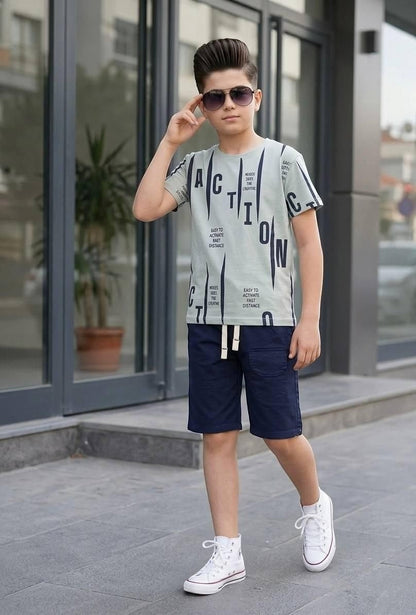The Nile Luxuries boys' graphic t-shirt and navy shorts set with drawstring waist, worn by a boy in sunglasses.