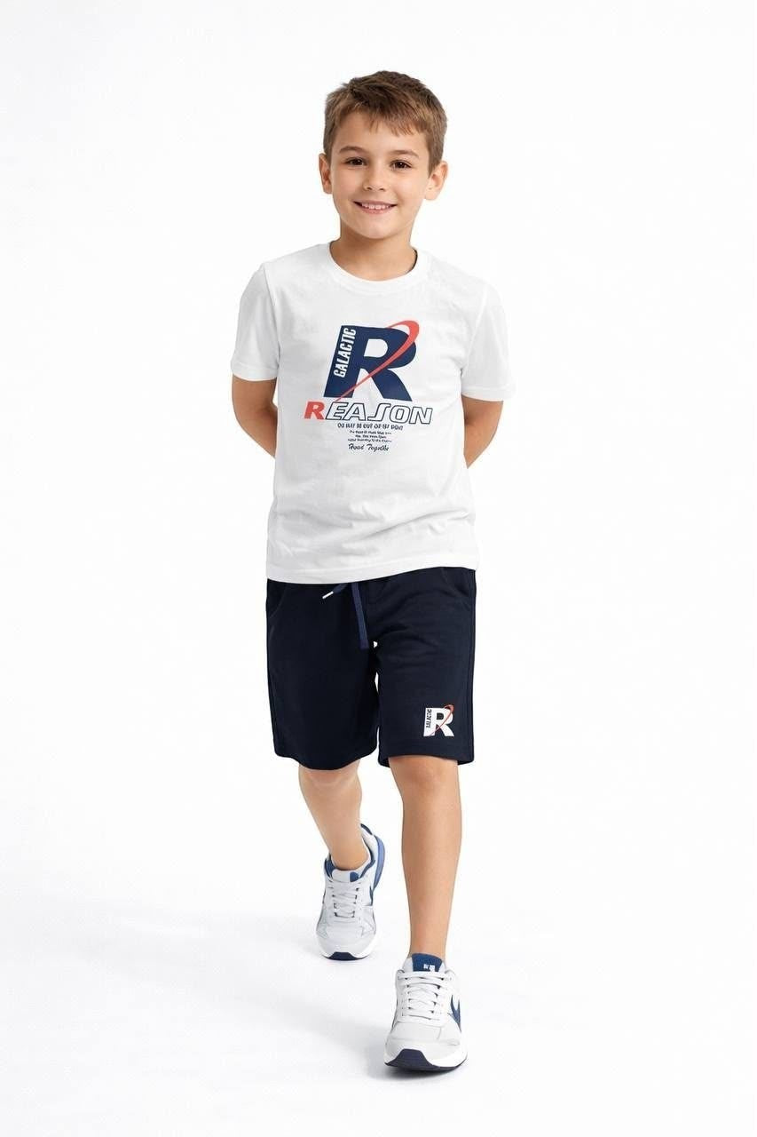 Young boy wearing The Nile Luxuries white graphic t-shirt and navy blue athletic shorts with drawstring waist