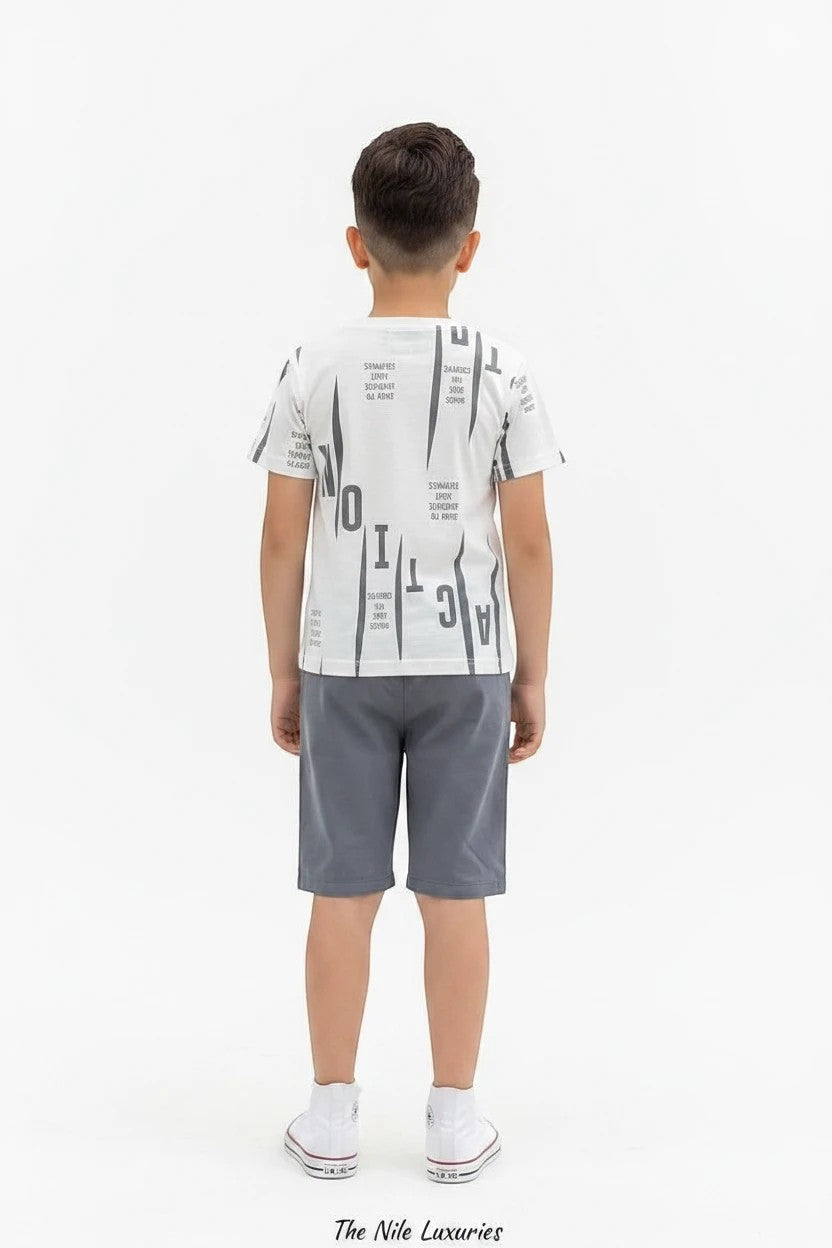 The Nile Luxuries boys casual set with white graphic t-shirt and grey shorts, worn by a boy with white sneakers.