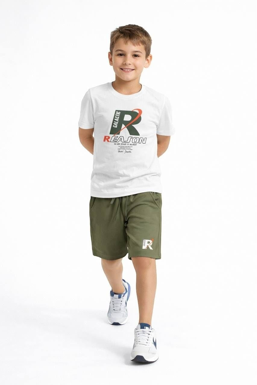 The Nile Luxuries boys' white graphic t-shirt and olive green drawstring shorts outfit set on a smiling young boy.