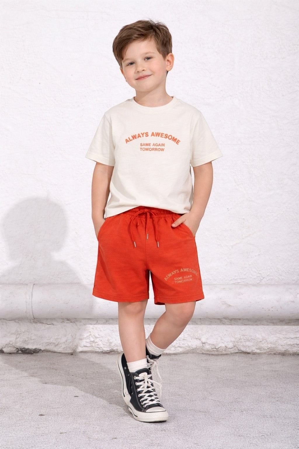 The Nile Luxuries boys lounge set featuring a cream t-shirt and red shorts with Always Awesome graphic text.