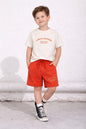 The Nile Luxuries boys lounge set featuring a cream t-shirt and red shorts with Always Awesome graphic text.