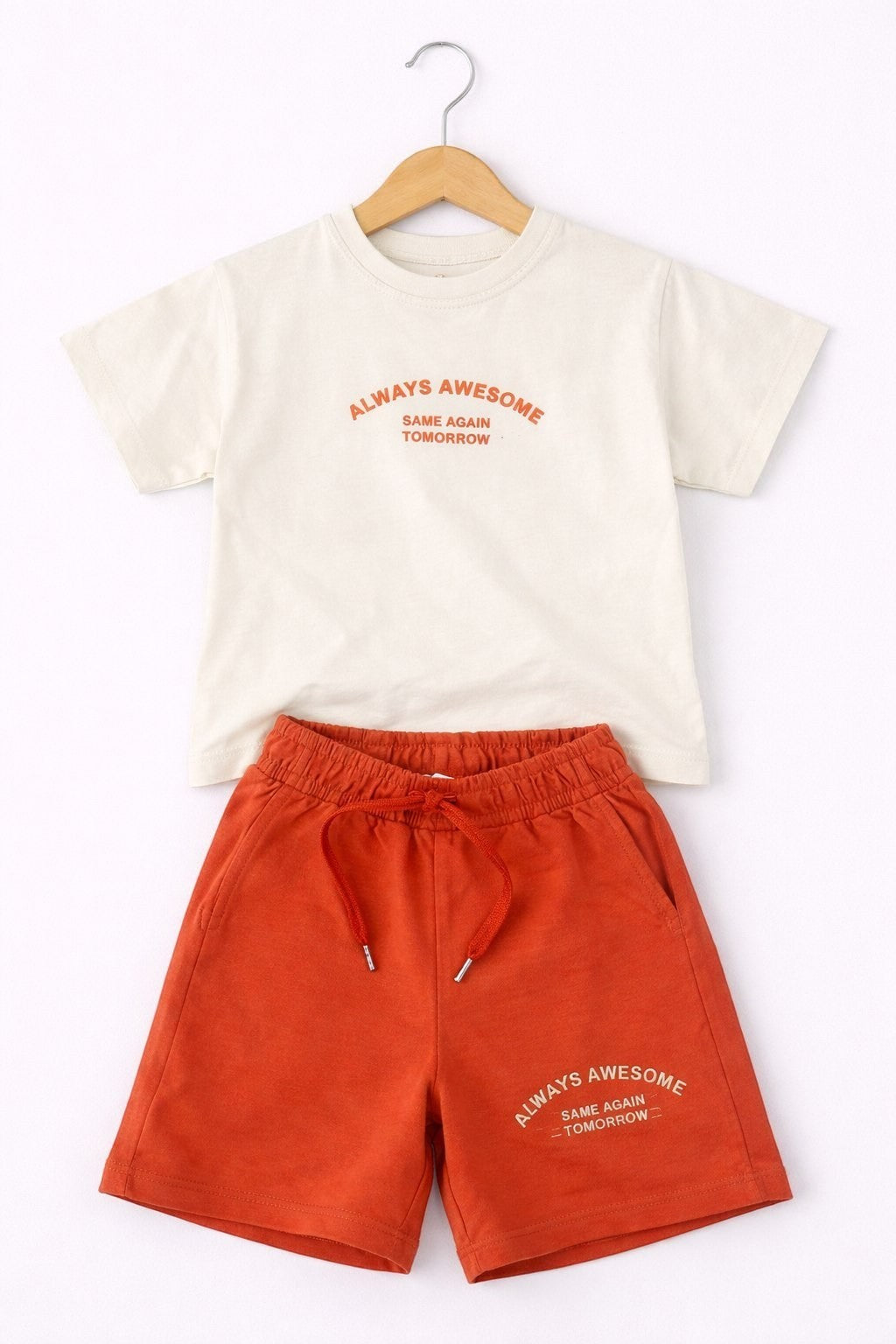 The Nile Luxuries boys lounge set with a cream t-shirt and rust orange shorts featuring Always Awesome graphic print.