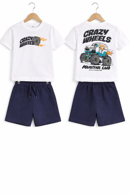 The Nile Luxuries boys' white graphic t-shirt with monster truck print and navy blue elastic waist shorts outfit set.