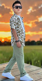 The Nile Luxuries boys' olive green abstract print short sleeve shirt and cargo pants set. Relaxed fit shirt with collar and button front.