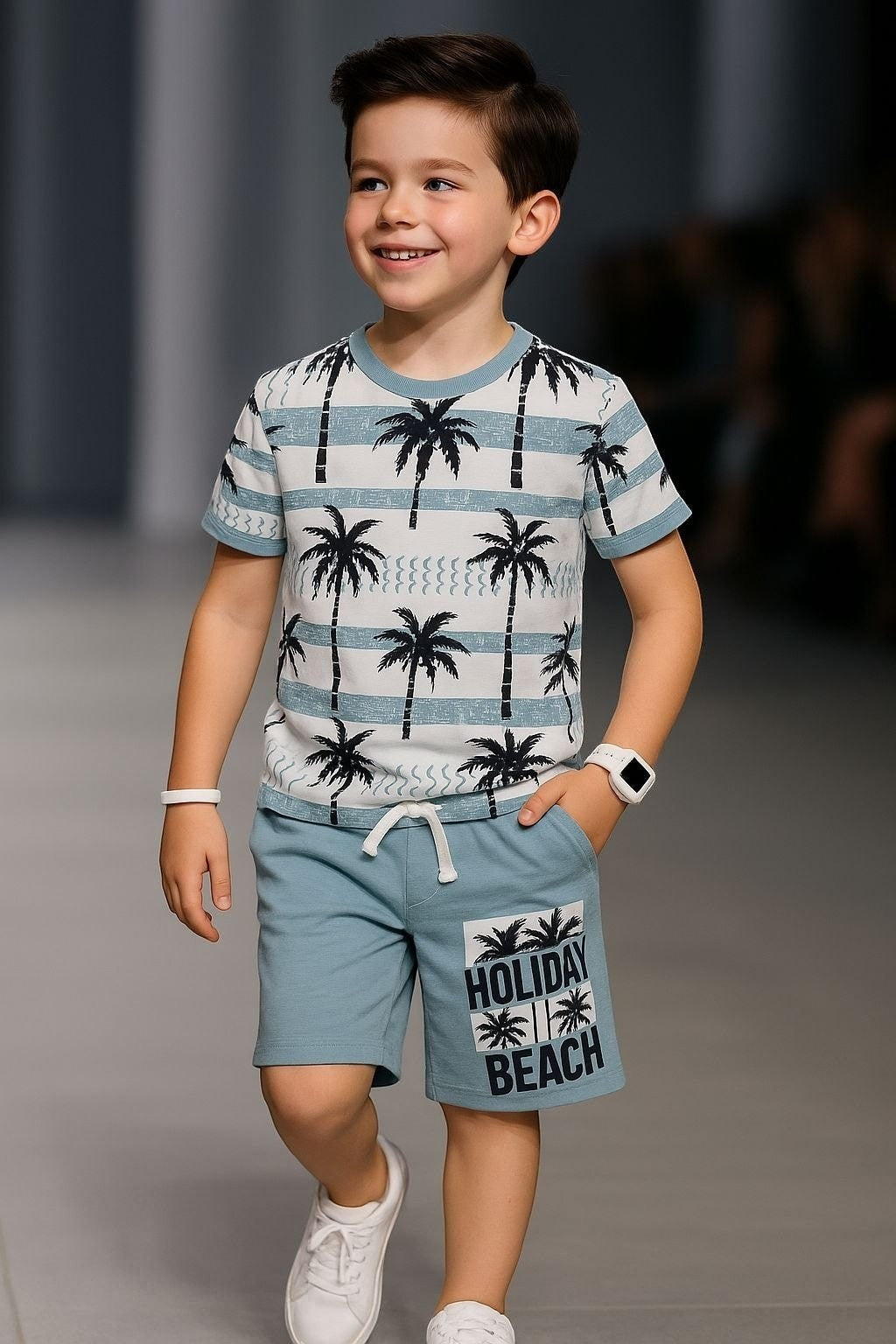 The Nile Luxuries boys' blue palm tree print t-shirt and shorts set. T-shirt has stripes and palm trees. Shorts have "Holiday Beach" graphic.