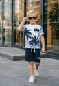 The Nile Luxuries boys' blue and white palm tree print t-shirt with navy shorts set. Features GAP logo.