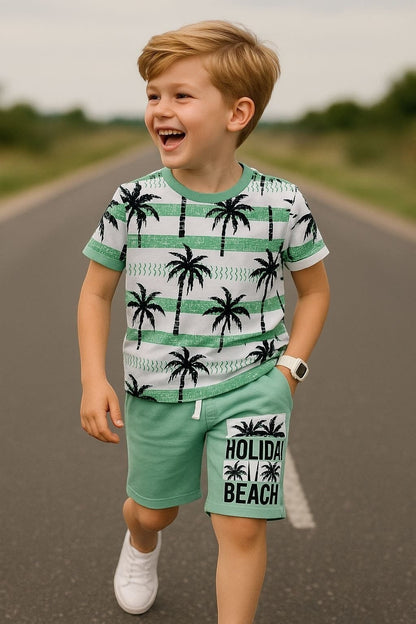 The Nile Luxuries boys' green palm tree print t-shirt and shorts set. T-shirt has white stripes and palm trees. Shorts have "Holiday Beach" graphic.