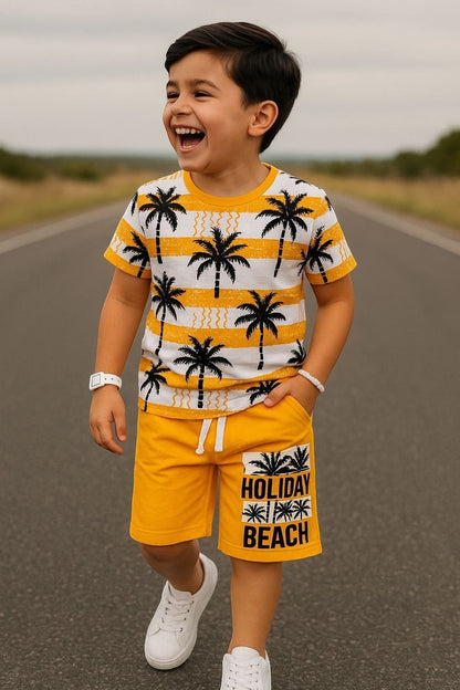 The Nile Luxuries boys' yellow palm tree print t-shirt and shorts set. T-shirt has white stripes and palm trees. Shorts have "Holiday Beach" graphic.