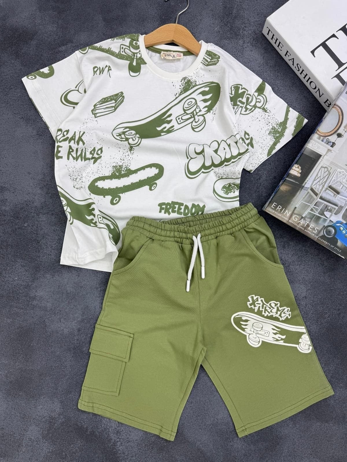 The Nile Luxuries kids set featuring a white graphic t-shirt and olive green cargo shorts with skateboard prints.