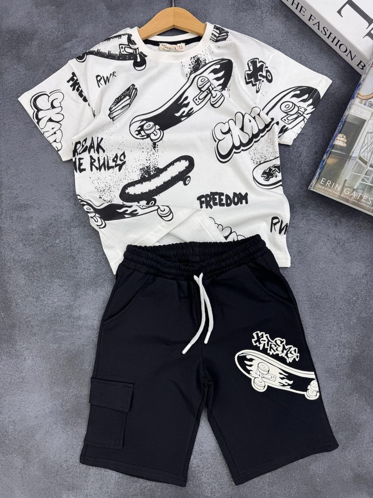 The Nile Luxuries kids set with white graphic t-shirt and black cargo shorts featuring skateboard print designs.
