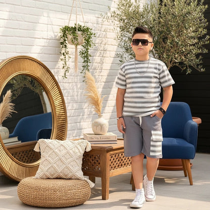 The Nile Luxuries boys summer outfit with a grey striped t-shirt and cargo shorts worn by a boy in sunglasses.