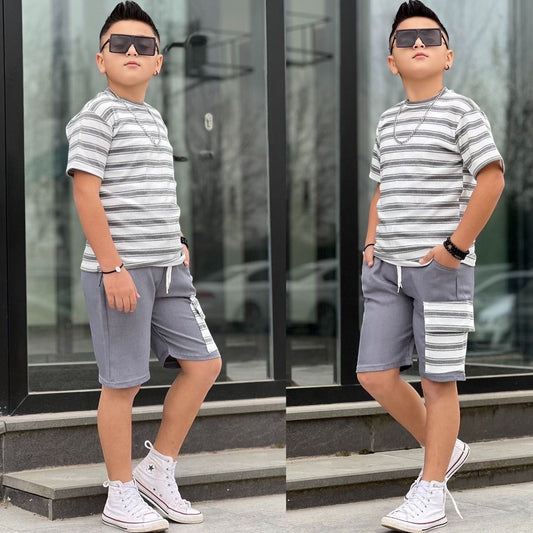 The Nile Luxuries boys summer outfit with a grey striped t-shirt and matching cargo shorts with white sneakers.