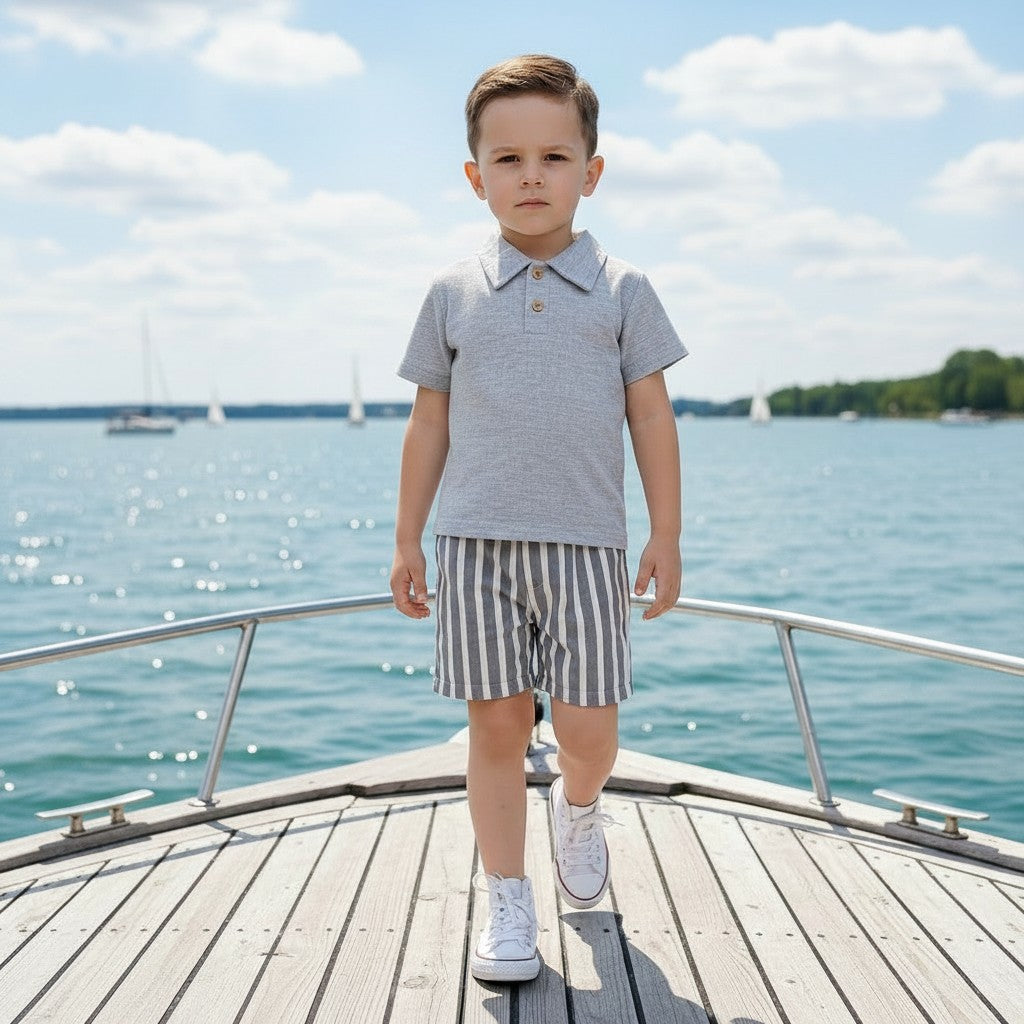 The Nile Luxuries boys' grey polo shirt and striped shorts set. Linen-blend fabric, two-button placket, elastic waistband.