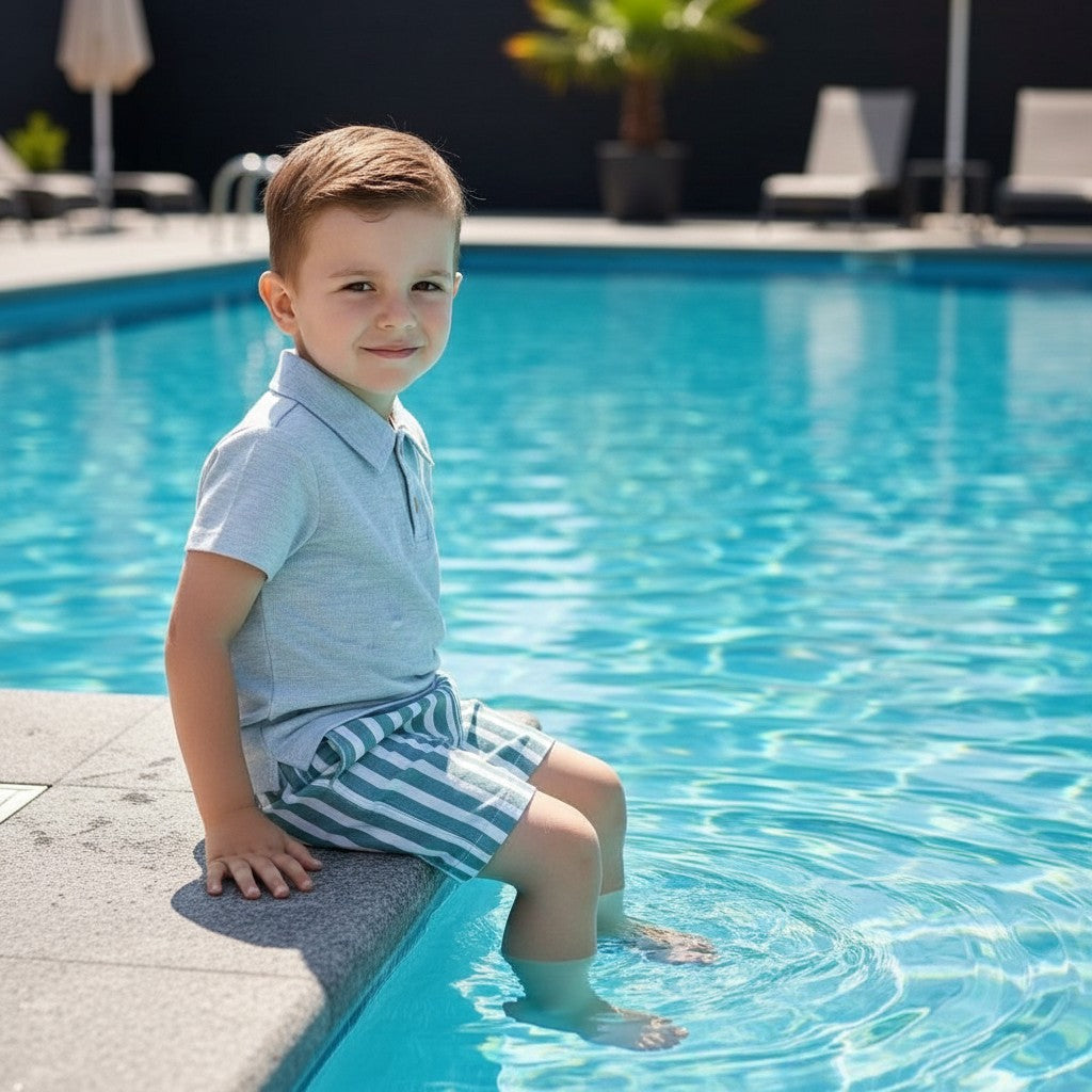 The Nile Luxuries boys' light blue linen-blend polo shirt and green striped shorts set with sunglasses.