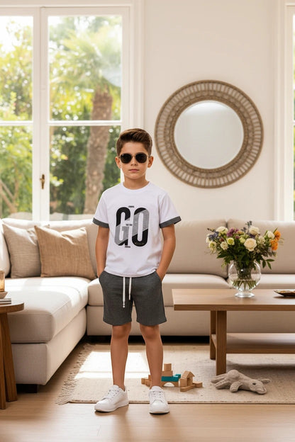 The Nile Luxuries boys white cotton t-shirt with GO graphic and checkered shorts outfit set worn by a young boy